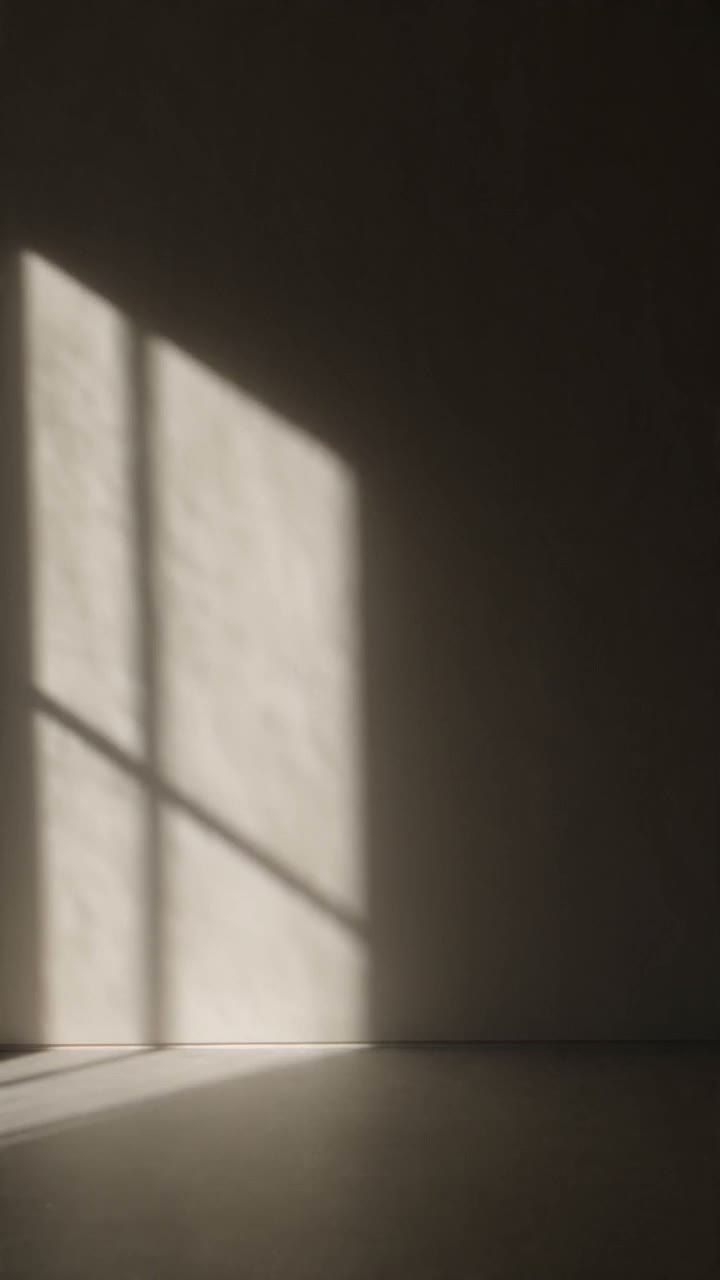 A brown leather lounge chair beside a floor lamp in a sunlit room